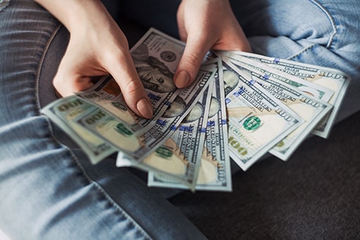 Down Payment – hands holding dollar bills